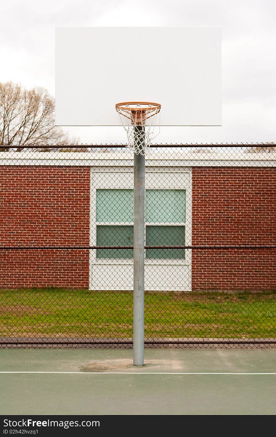 An outdoor basketball hoop at a children's school