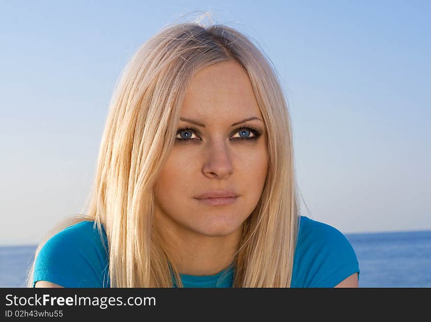 Beautiful blonde on sea background