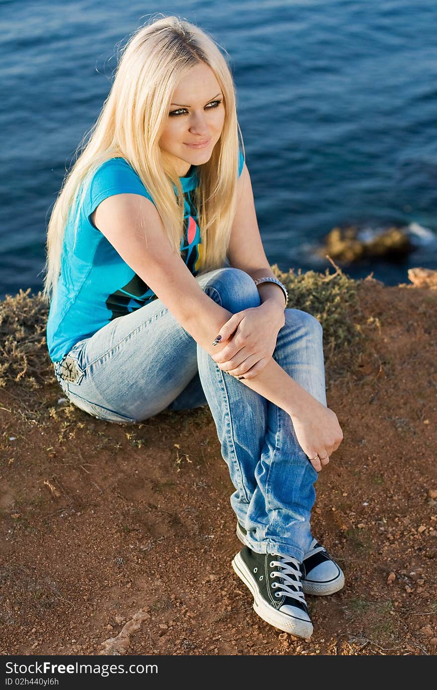 Beautiful blonde on sea background