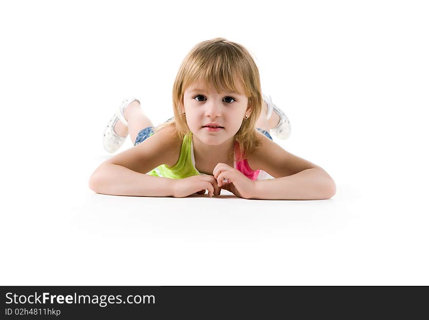 Cute little girl lie on the floor. Studio shot. Cute little girl lie on the floor. Studio shot