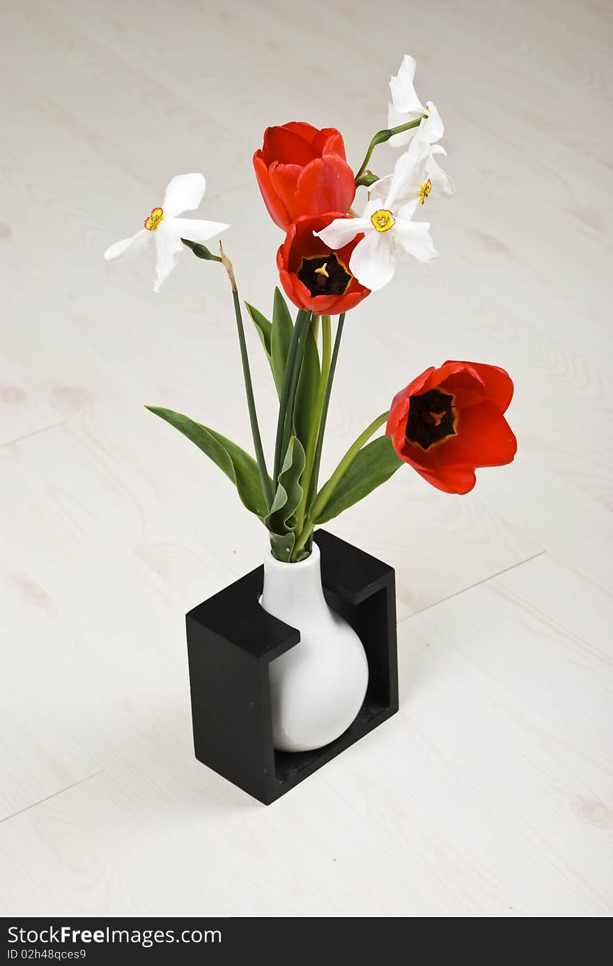 Bouquet of spring flowers in a vase on white laminate flooring ,check also Flowers. Bouquet of spring flowers in a vase on white laminate flooring ,check also Flowers