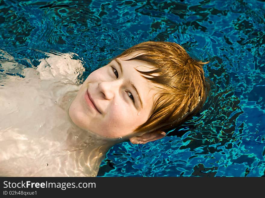 Boy with red hair in pool