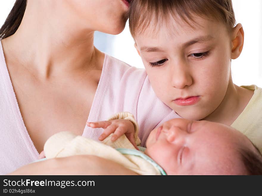 Mother Holds The Baby And Kissing  Son