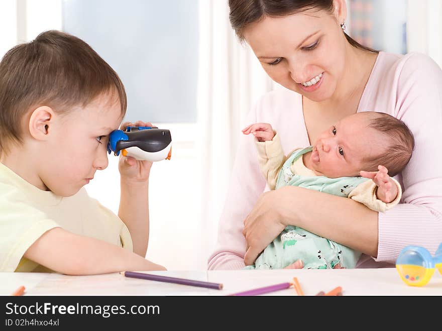 Boy looking through binoculars at the newborn