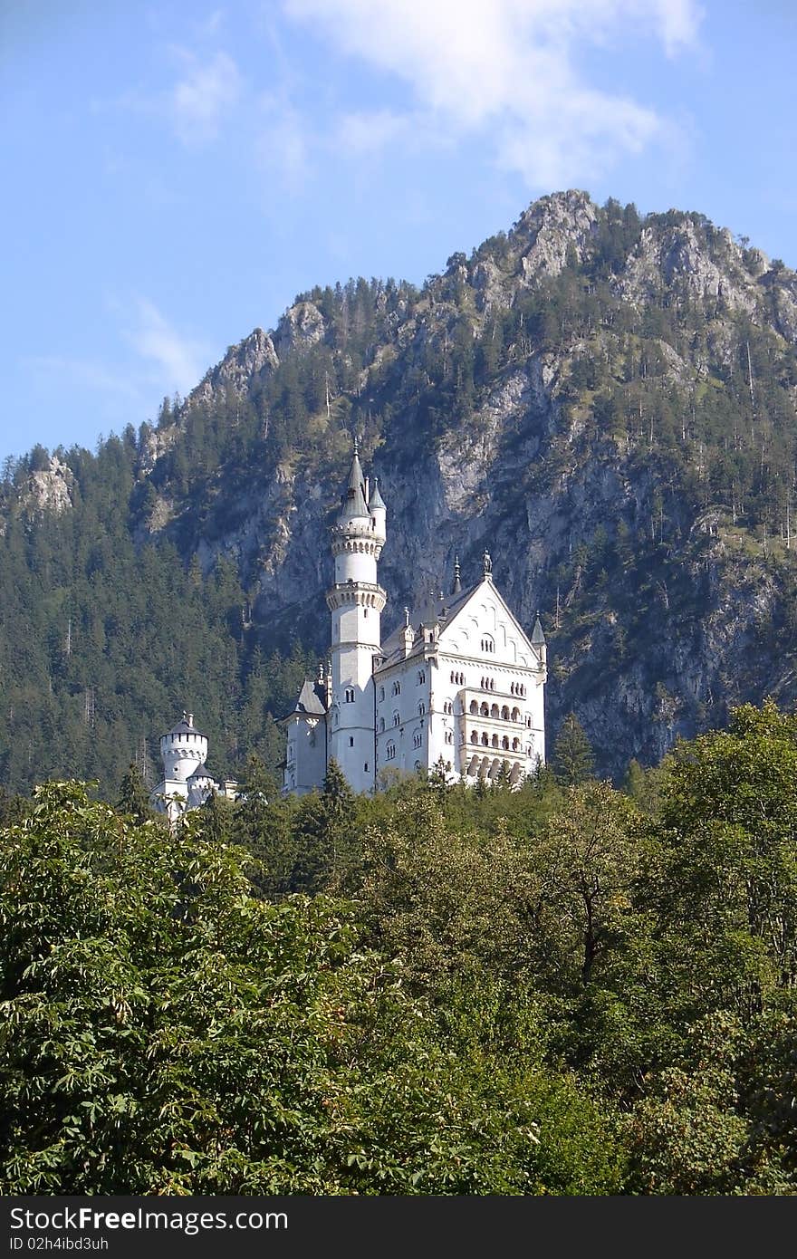 A beautiful small castle Neuschwanstein in Bavaria. View from valley. A beautiful small castle Neuschwanstein in Bavaria. View from valley.