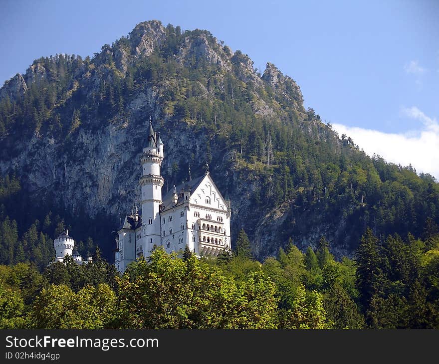 A beautiful small castle Neuschwanstein in Bavaria. View from valley. A beautiful small castle Neuschwanstein in Bavaria. View from valley.