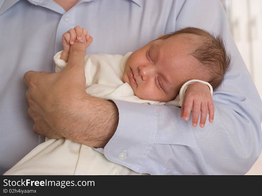 Newborn sleeping peacefully and keeps the finger father. Newborn sleeping peacefully and keeps the finger father