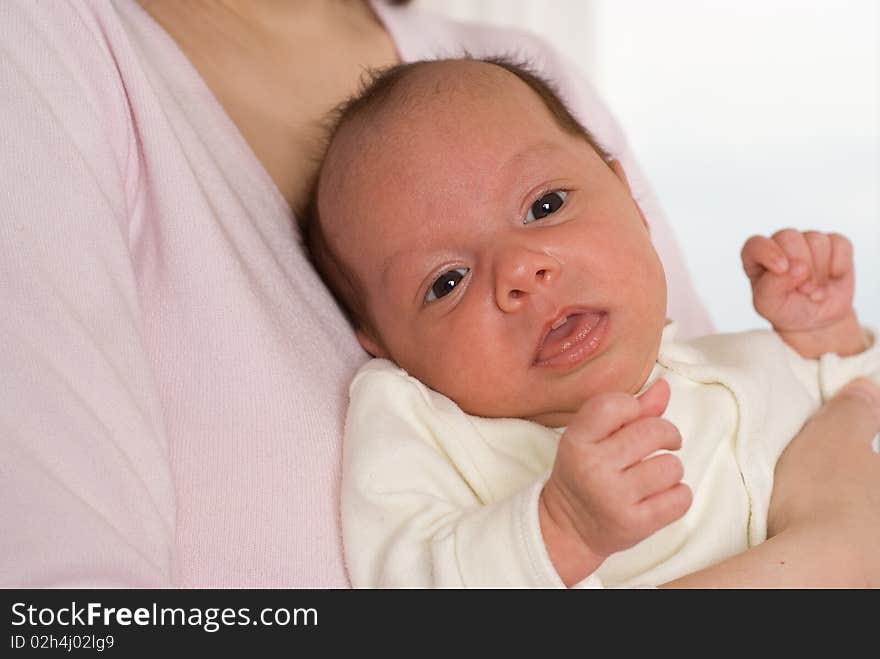 Young mother stands and holds the baby. Young mother stands and holds the baby