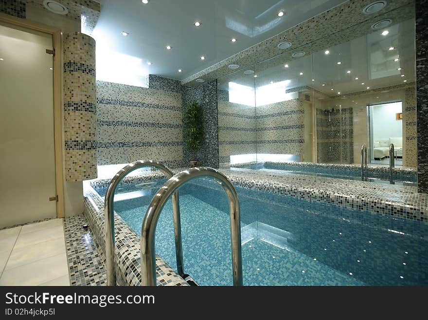 Swimming pool with big mirror in apartment