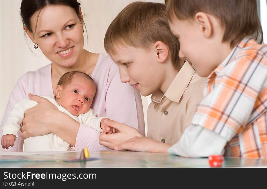 Mother with two sons and newborn at home. Mother with two sons and newborn at home