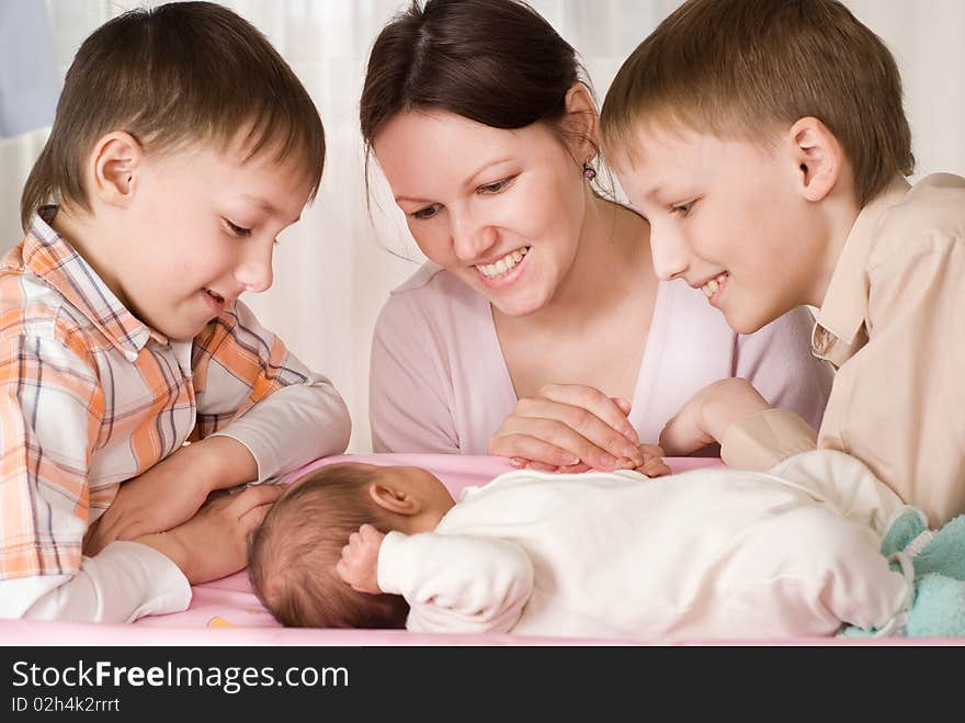 Young mother with three children standing together