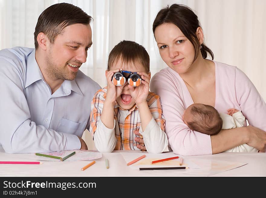 Family of four sitting at the table. Family of four sitting at the table