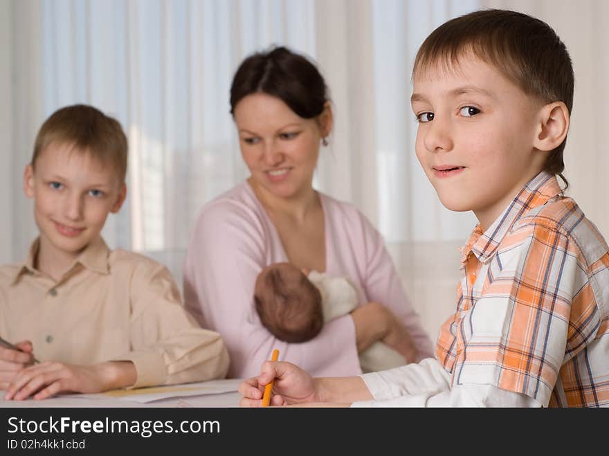 Young mother with three children at home