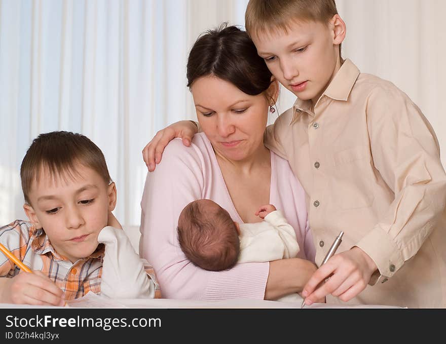 Young mother with three children at home