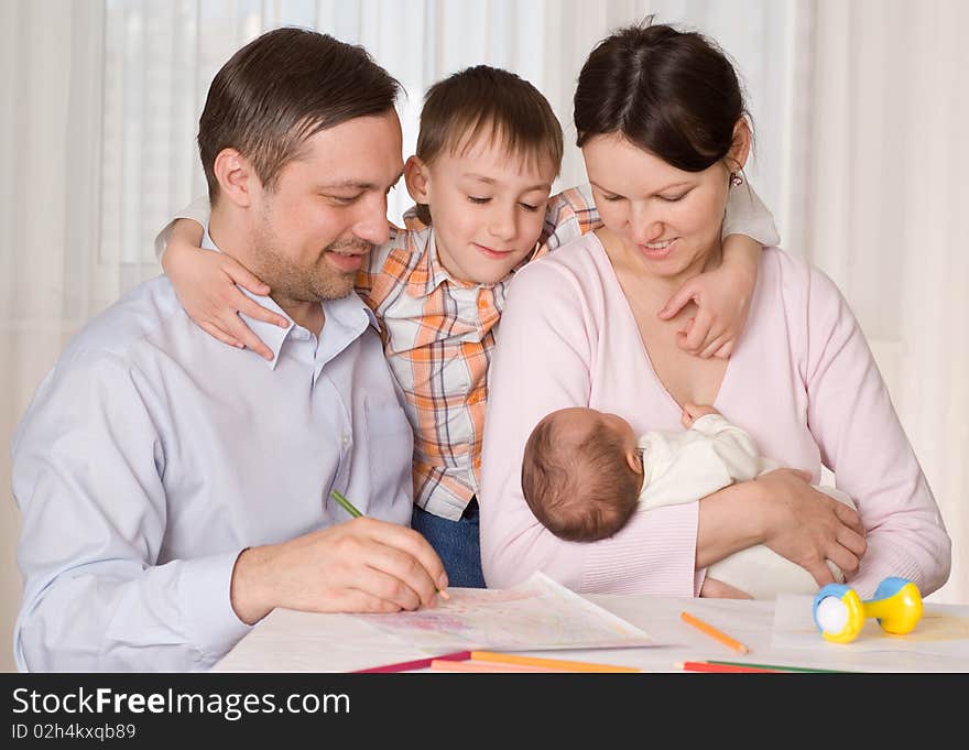 Happy couple with two children resting at home