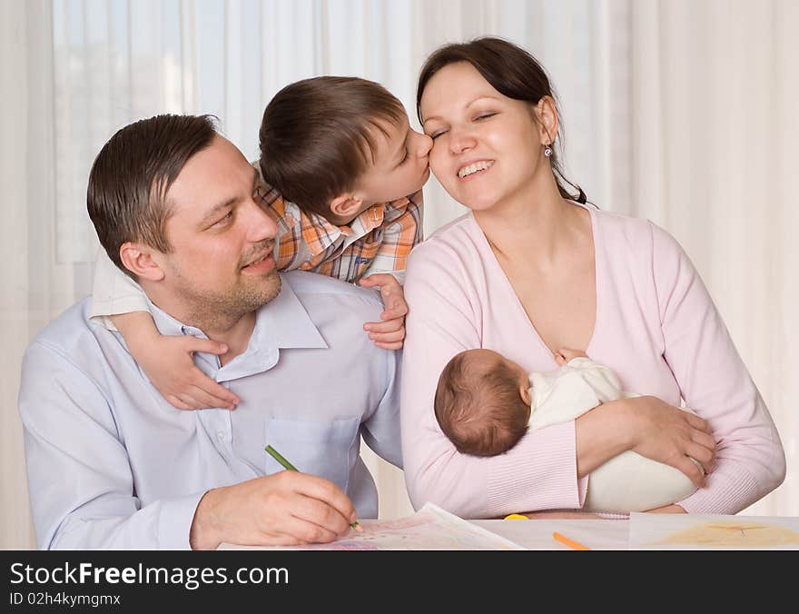 Happy couple with two children resting at home