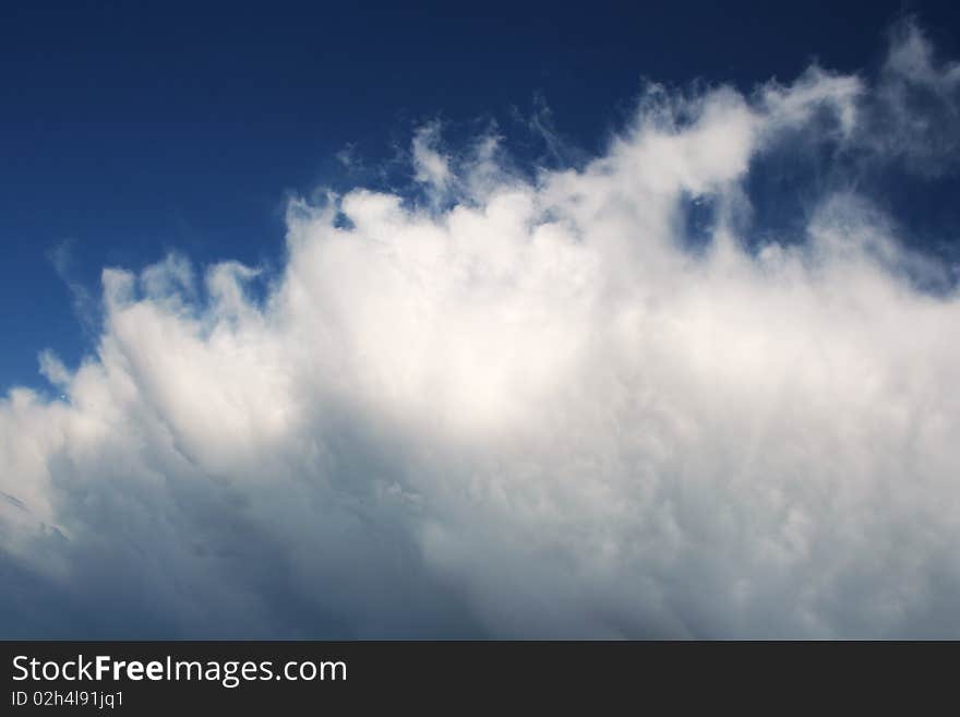 Dark storm cloud with blue sky