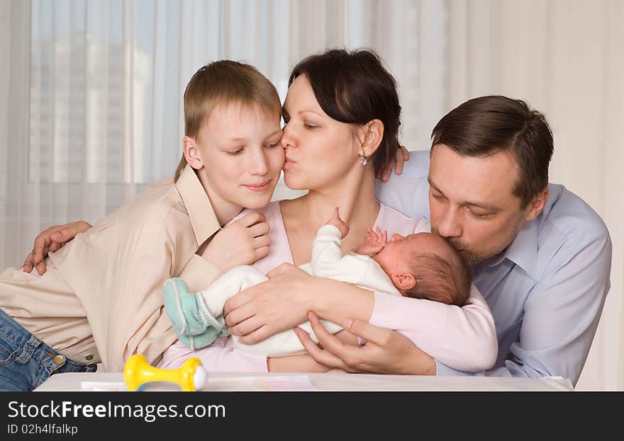 Happy young parents kissed his two children