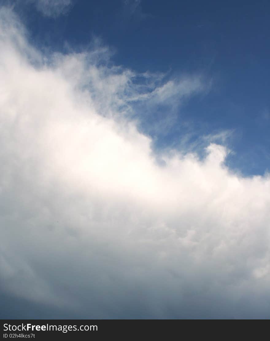 Dark storm cloud with blue sky