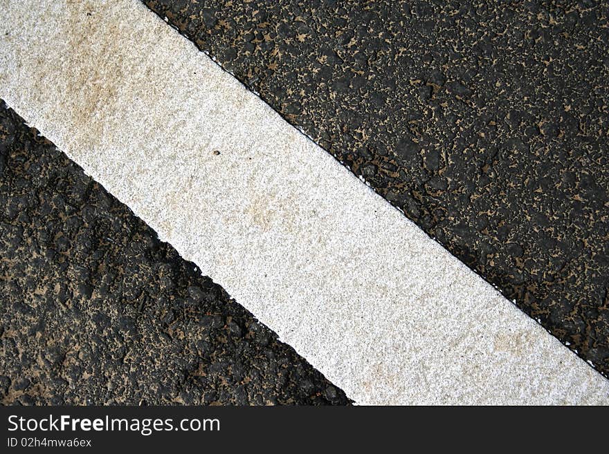 Grungy, dirty view of asphalt with distinct white stripe. Grungy, dirty view of asphalt with distinct white stripe