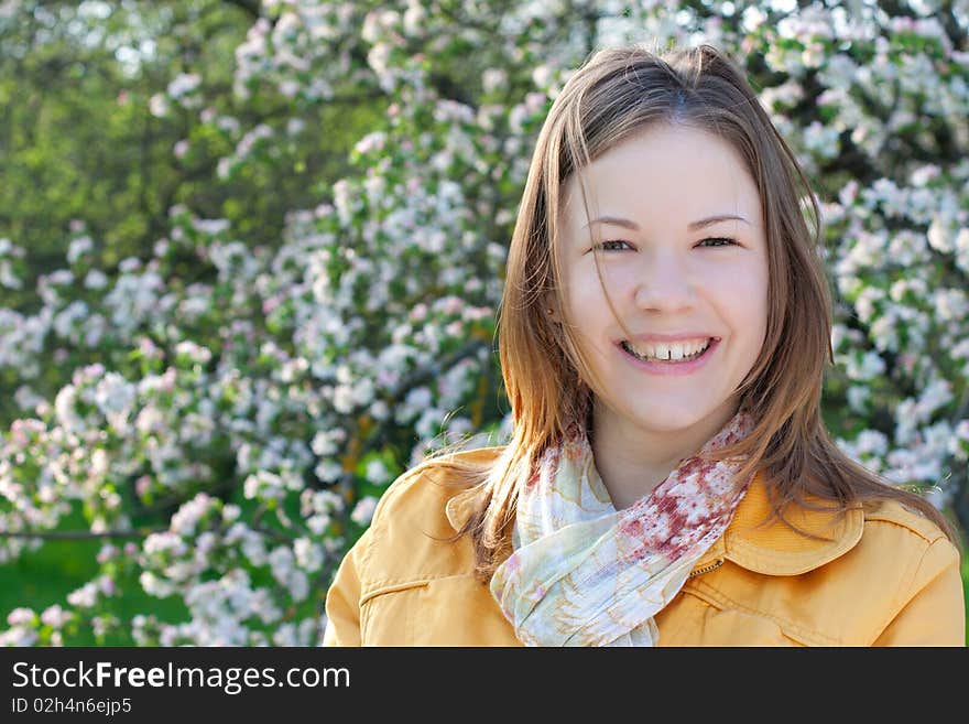 Young woman in blooming park