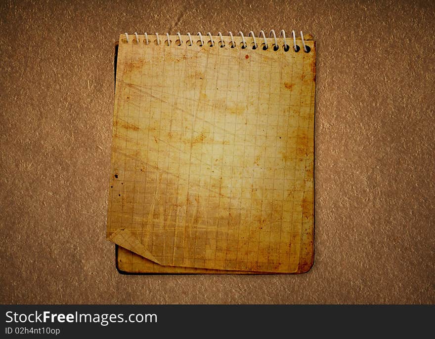 Dirty old notebook in a darkened background. Dirty old notebook in a darkened background