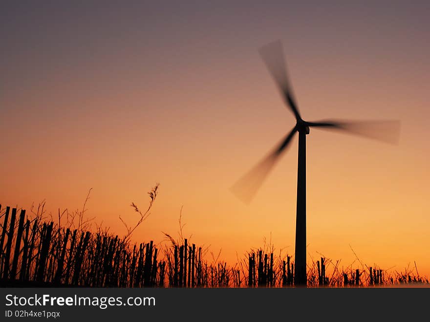 Electric windmill at sunset with beautiful sky.