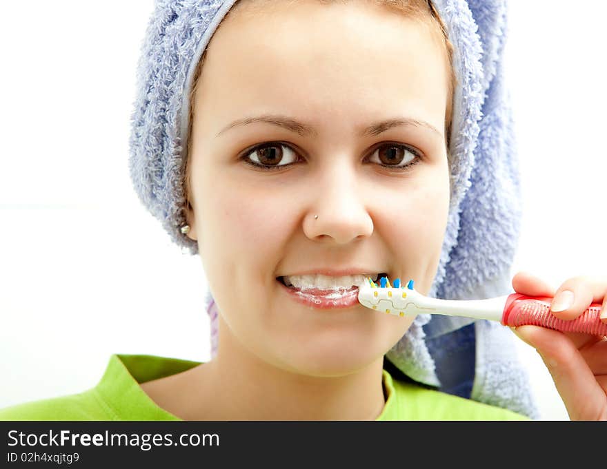 Pretty young girl brushing her teeth. Pretty young girl brushing her teeth