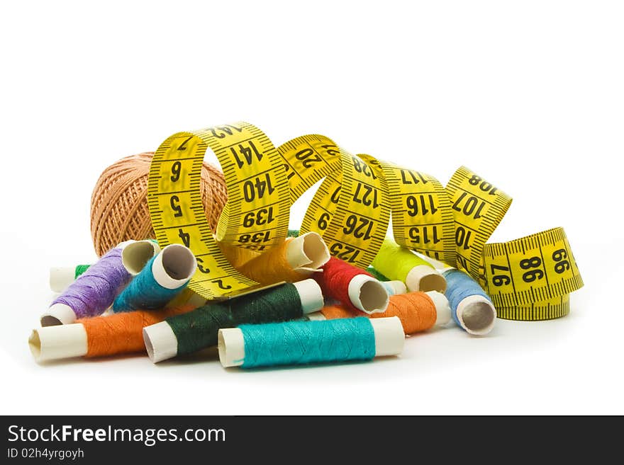 Colorful thread with yellow measuring tape isolated on white. Colorful thread with yellow measuring tape isolated on white