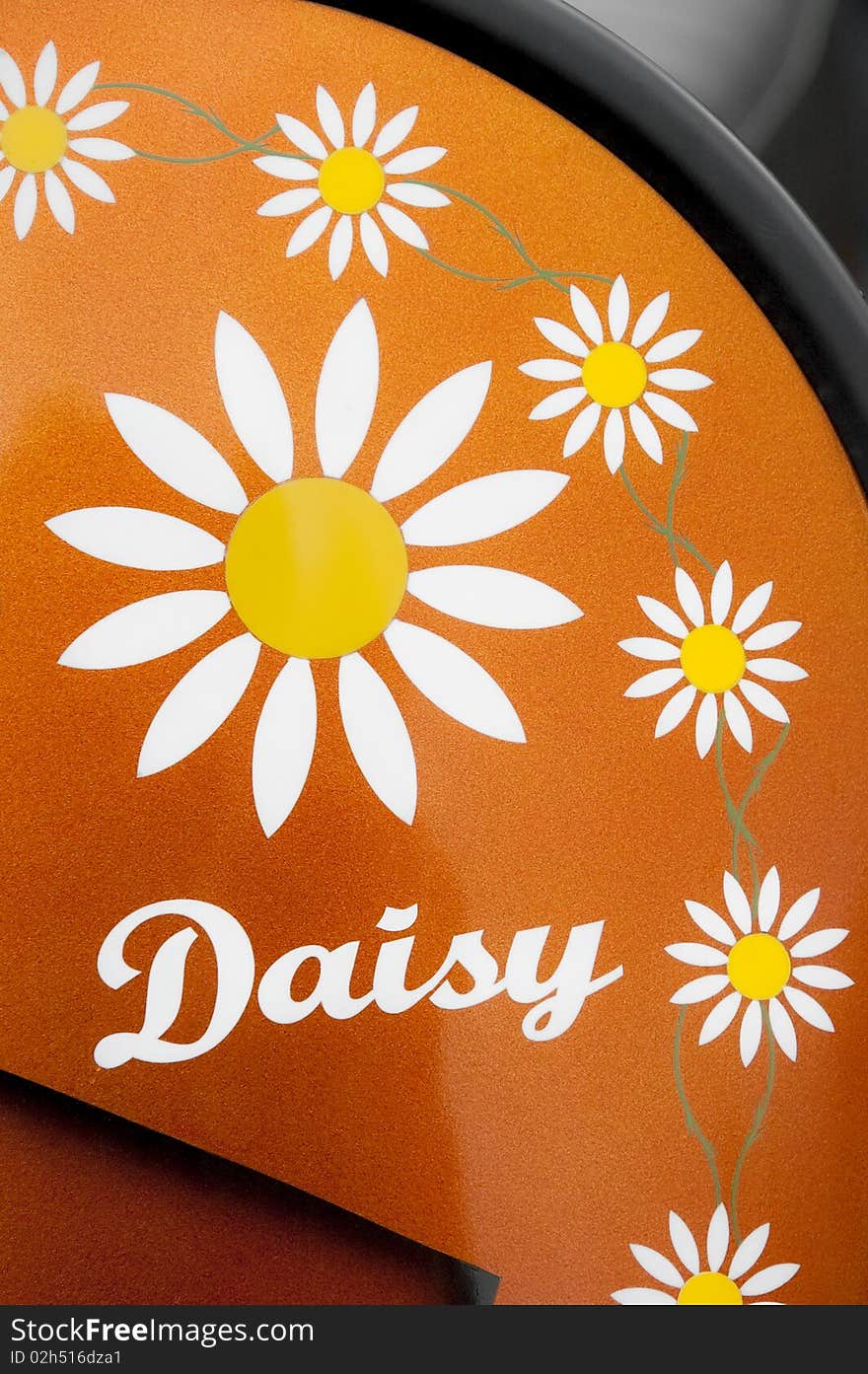 Multiple daisy patterns on an orange glitter vehicle panel