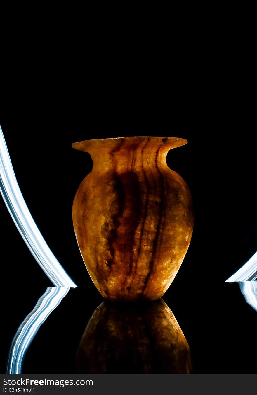 Alabaster vase illuminated by light rays