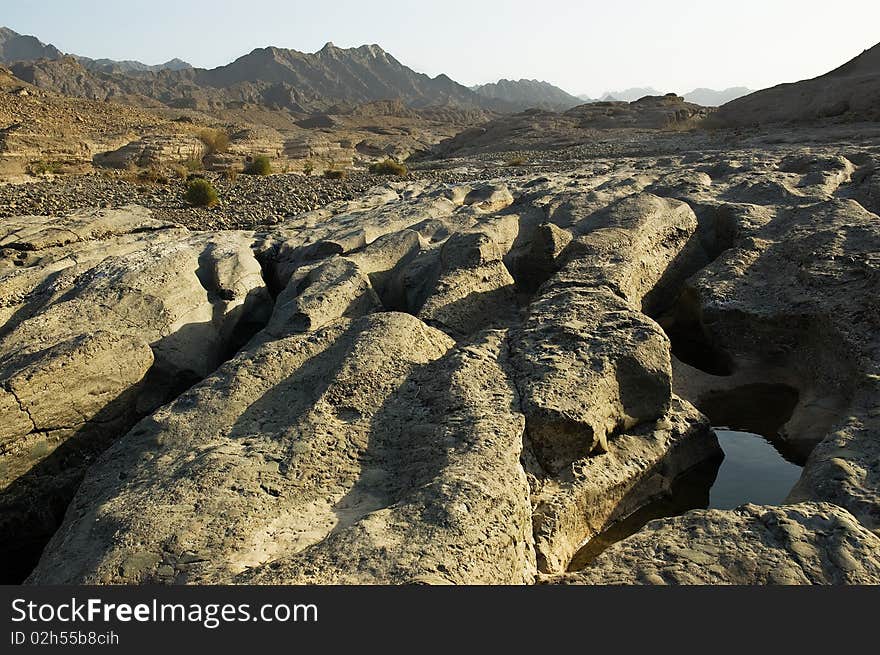 Dry river-bed, faraway mountains. Dry river-bed, faraway mountains