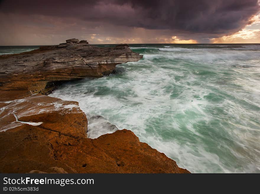 Image of a sunset with rain in the background in  South Africa near Cape Town. Image of a sunset with rain in the background in  South Africa near Cape Town