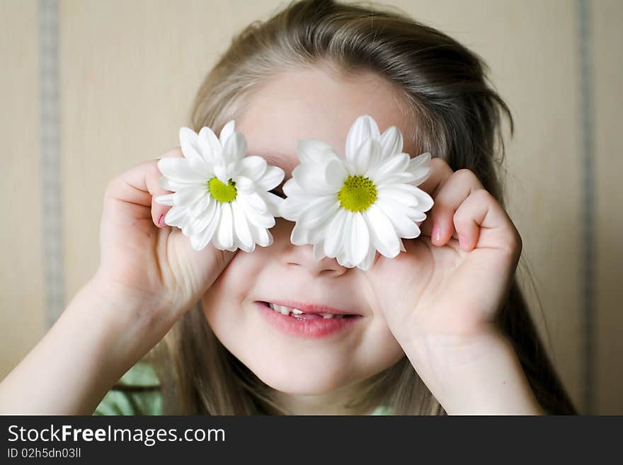 An image of a girl with camomiles on her eyes. An image of a girl with camomiles on her eyes