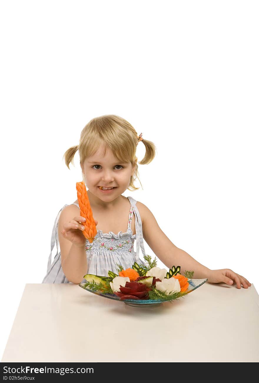 Little girl eating vegetables - chomping a carrot - isolated