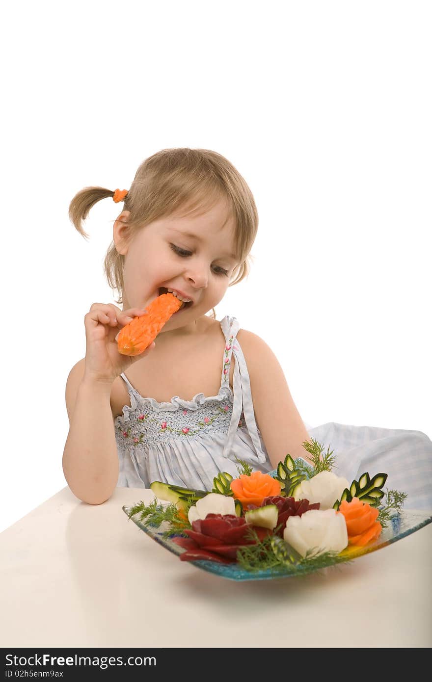 Little girl eating vegetables - chomping a carrot - isolated