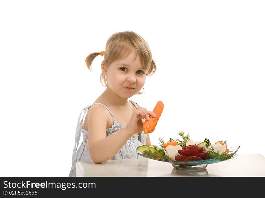 Little girl eating vegetables - isolated