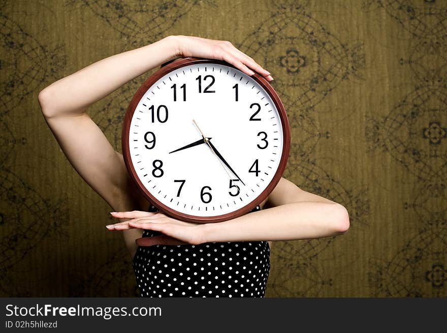 An image of a girl holding a big clock