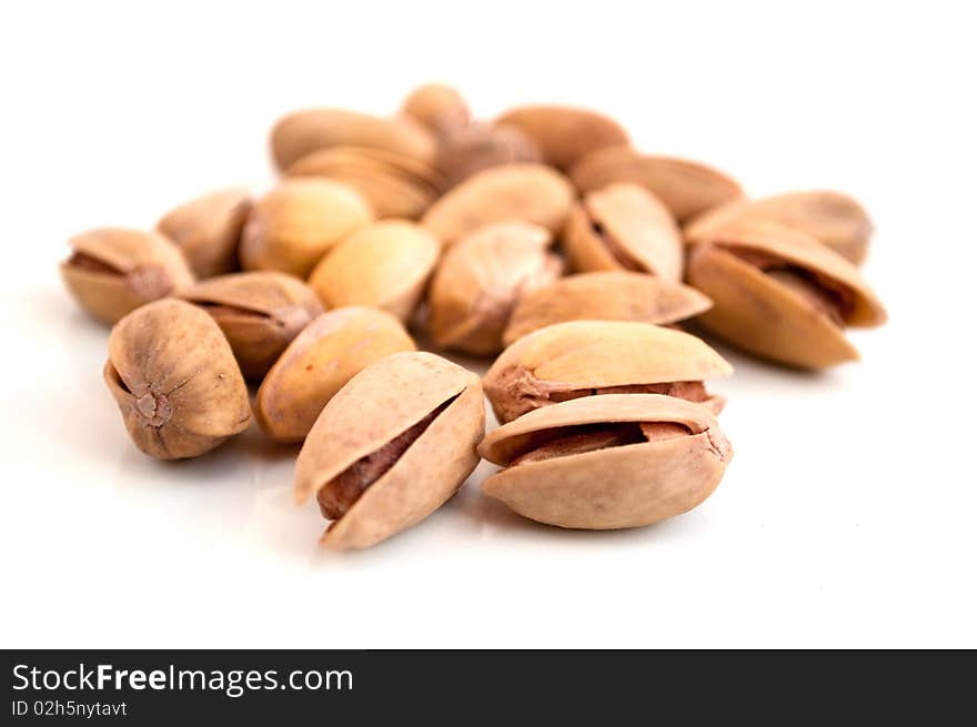 Fried pistachios on a white background