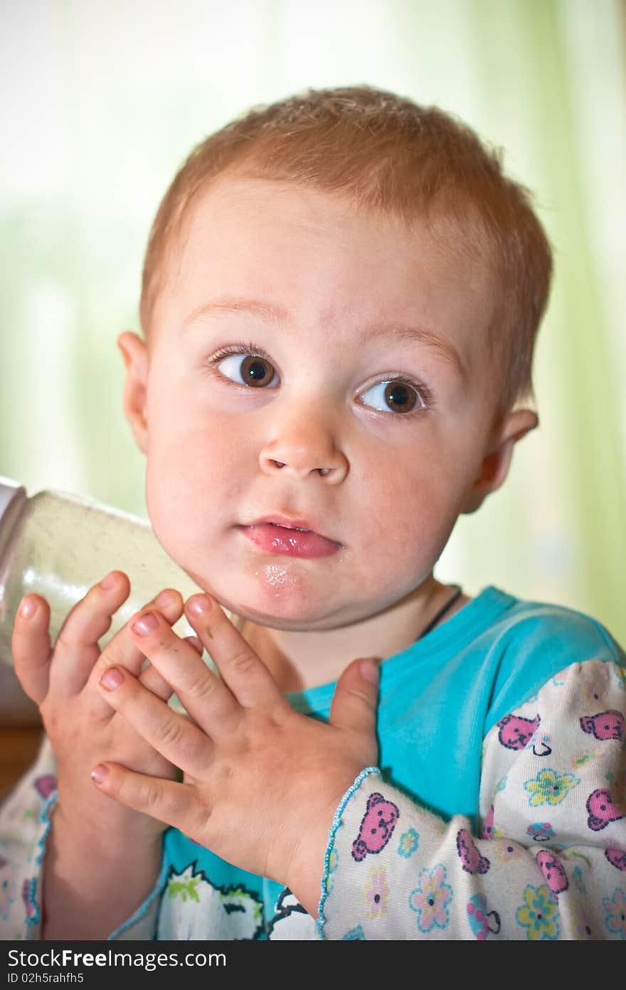 Young Baby Boy With Bottle Of Juice