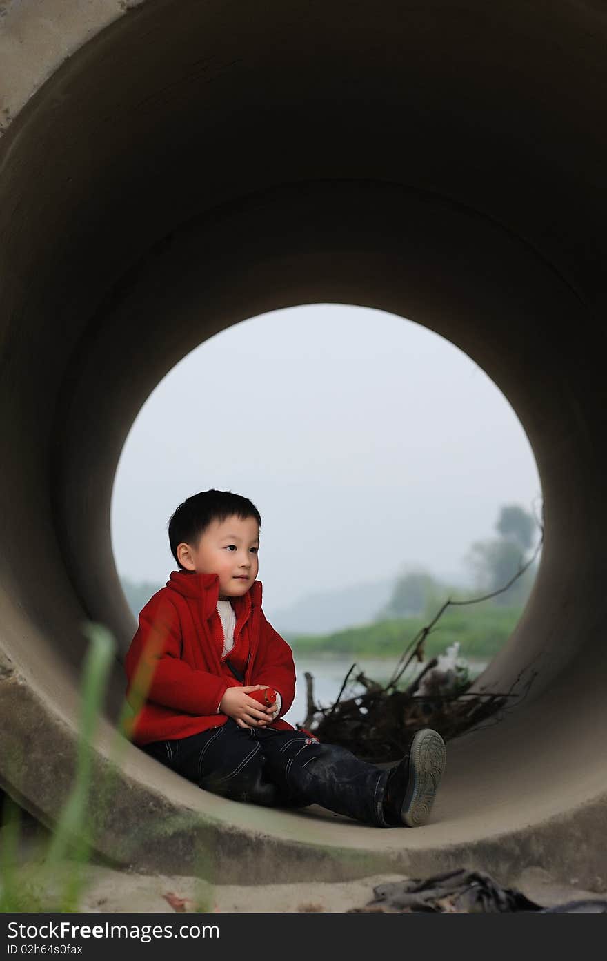 Cute little boy in Sewer in red.