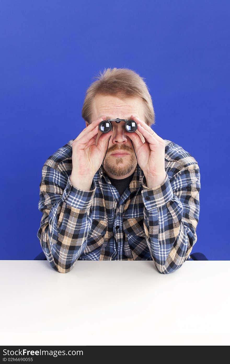 Man watches with binoculars