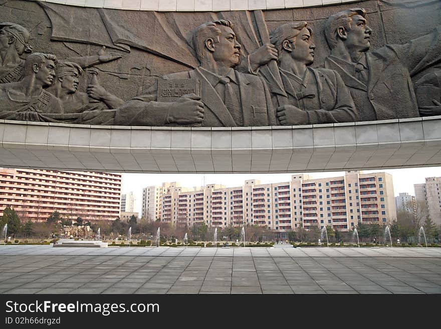 The political sculpture in front of the residential area. Korean characters on political sculpture is Juche idea. The political sculpture in front of the residential area. Korean characters on political sculpture is Juche idea.