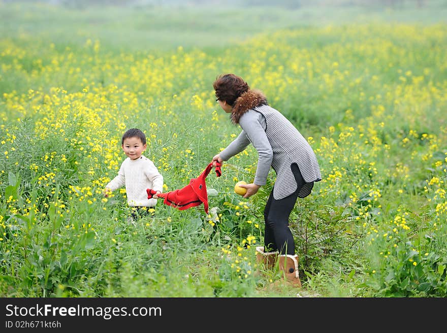 Mother and son outdoor in flowers. Mother and son outdoor in flowers.