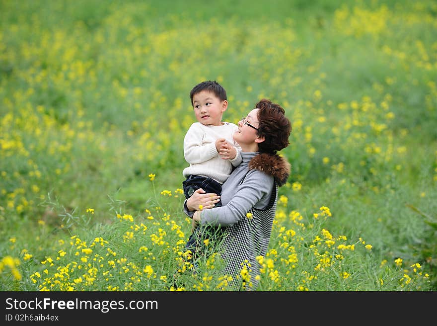 Mother and son outdoor in flowers. Mother and son outdoor in flowers.