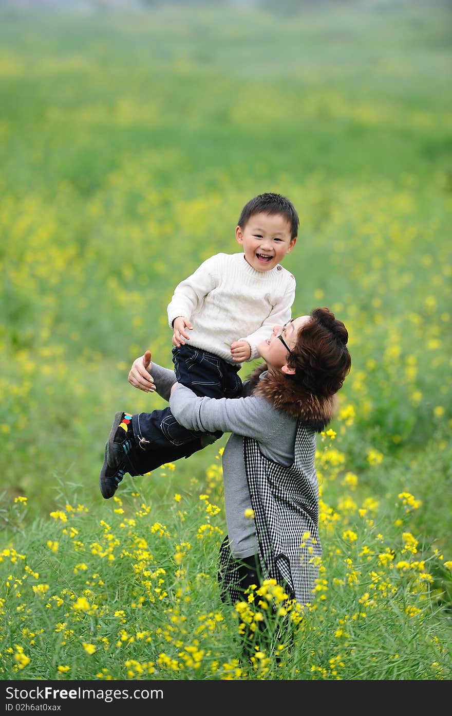 Mother and son outdoor in flowers. Mother and son outdoor in flowers.