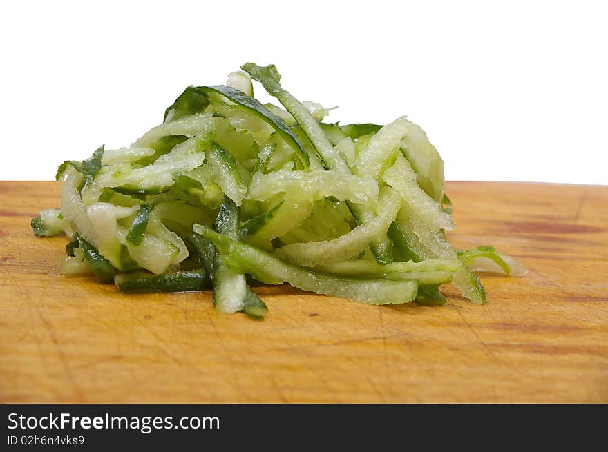 Green small cucumber  grated on wooden board