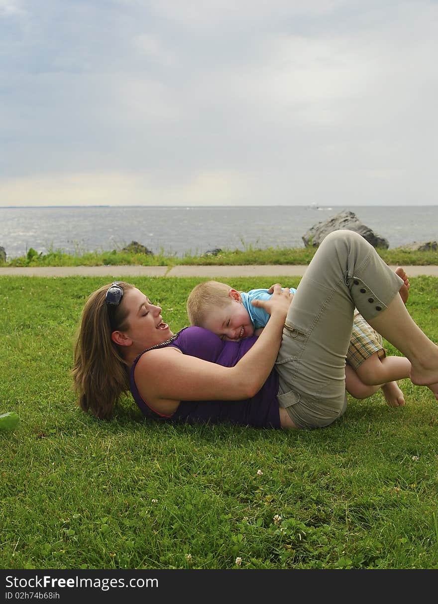 Mother and child playing on beach focus on child.