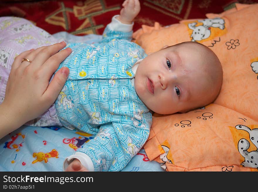 Photo of the beautiful baby lying on bed