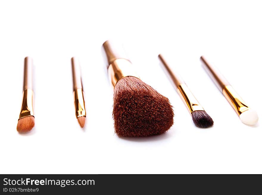 Five metal makeup brushes isolated on white. Five metal makeup brushes isolated on white